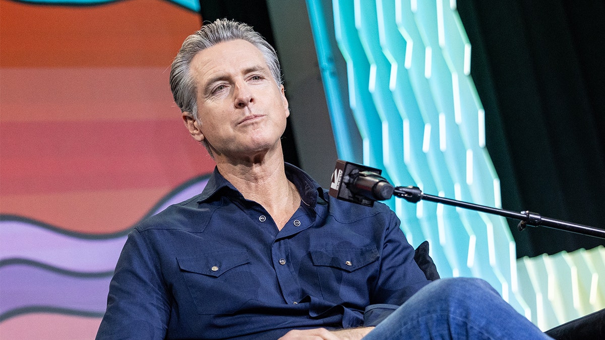 Gavin Newsom speaking on stage at the SXSW Conference and Festival in Austin, Texas