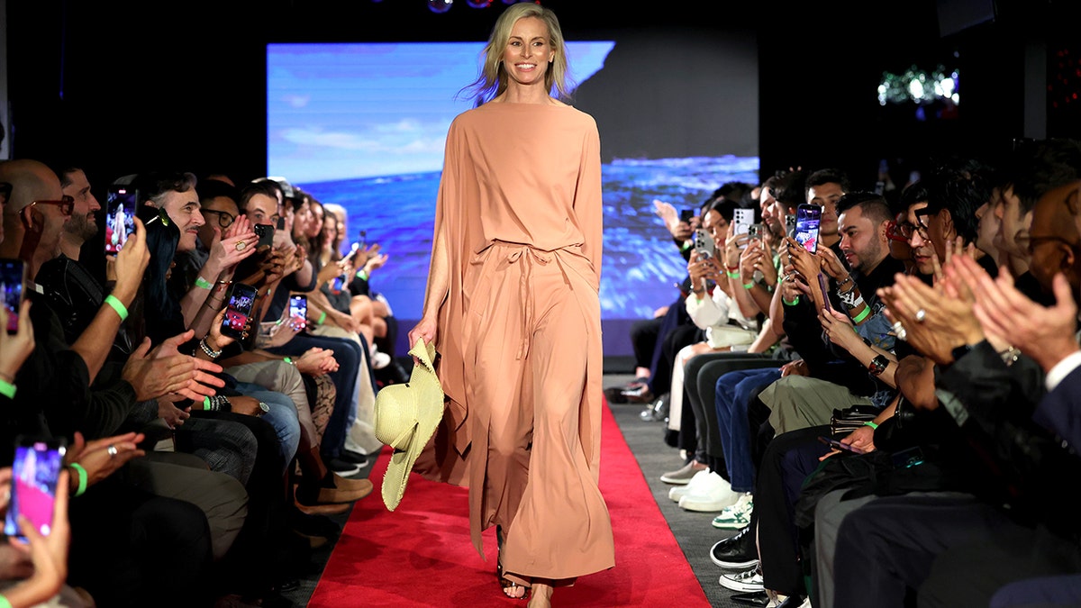 Model Niki Taylor walks down a runway at a fashion presentation in New York City.