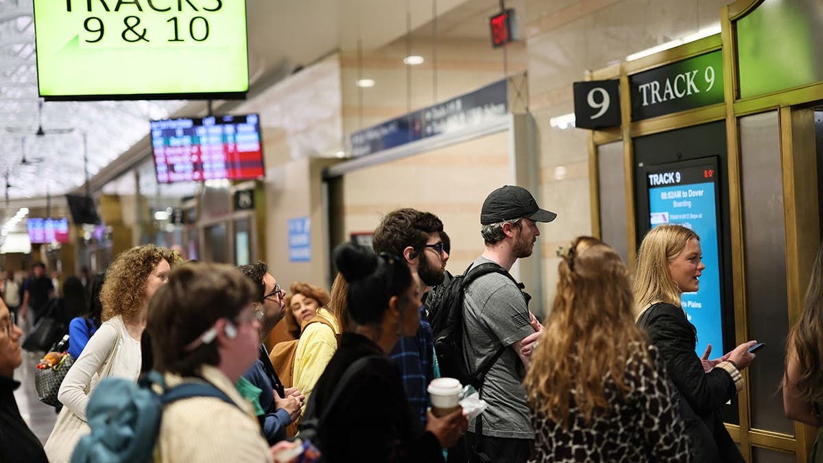 Commuters waiting for their train at the NJ Transit section of Penn Station in New York City