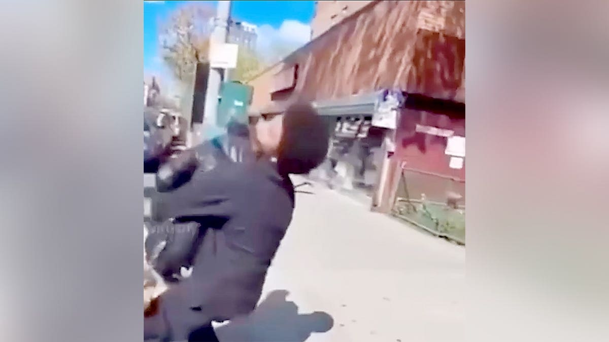 Boy flipping girl onto sidewalk.