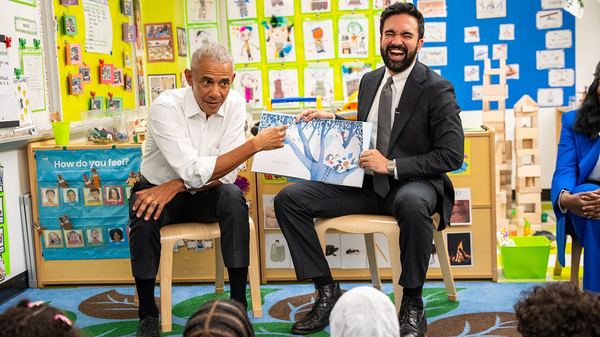 Former President Barack Obama and Mayor Zohran Mamdani reading a book to children at a preschool.