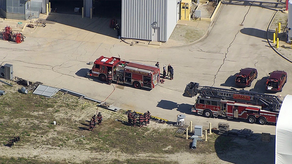 A reddish  occurrence  motor  parked connected  a factual  batch  with firefighters standing