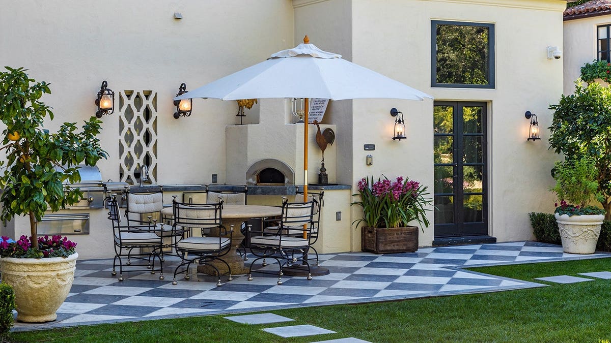 An outdoor dining area with a kitchen