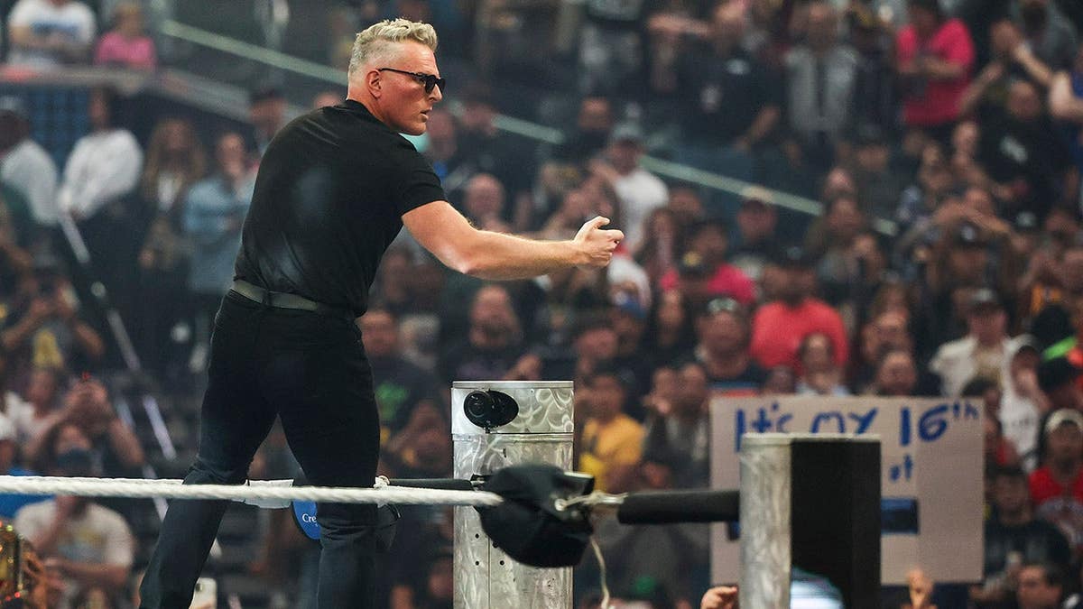 Pat McAfee greeting fans from the ring at WrestleMania 42 in Las Vegas