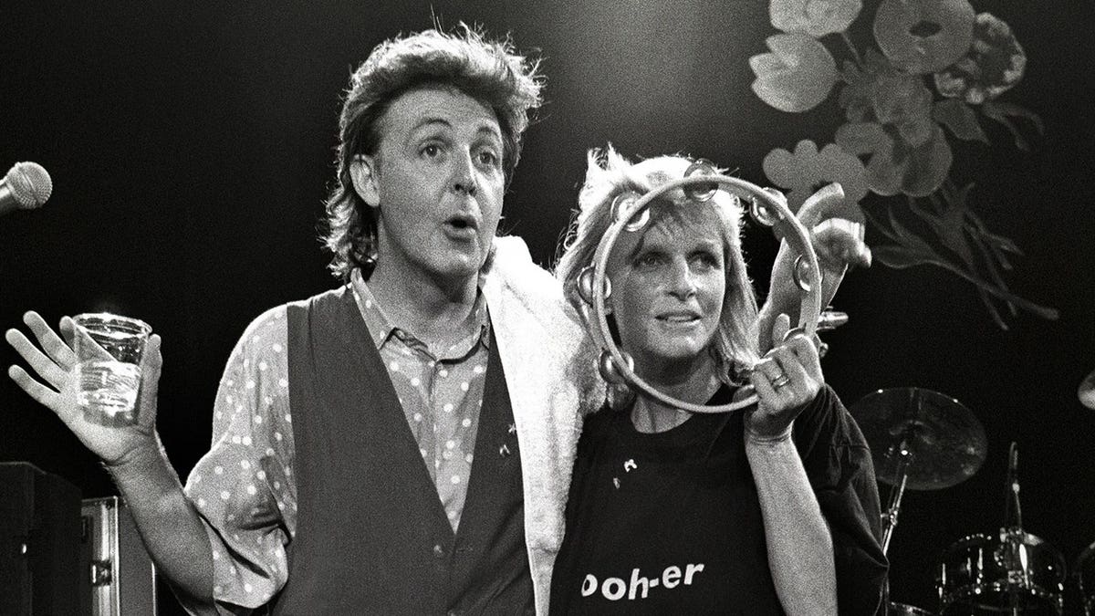Paul McCartney, and wife Linda McCartney pose on stage in London in July 1989