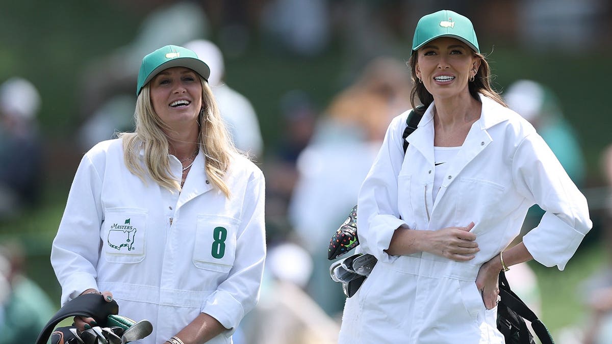 Nicole Willett and Paulina Gretzky watching the Par Three Contest astatine  Augusta National Golf Club