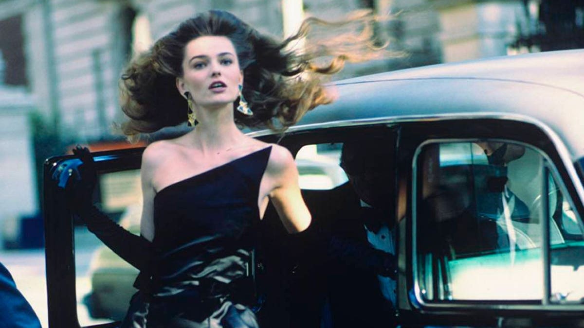 Model Paulina Porizkova stepping from a car wearing a black silk dress