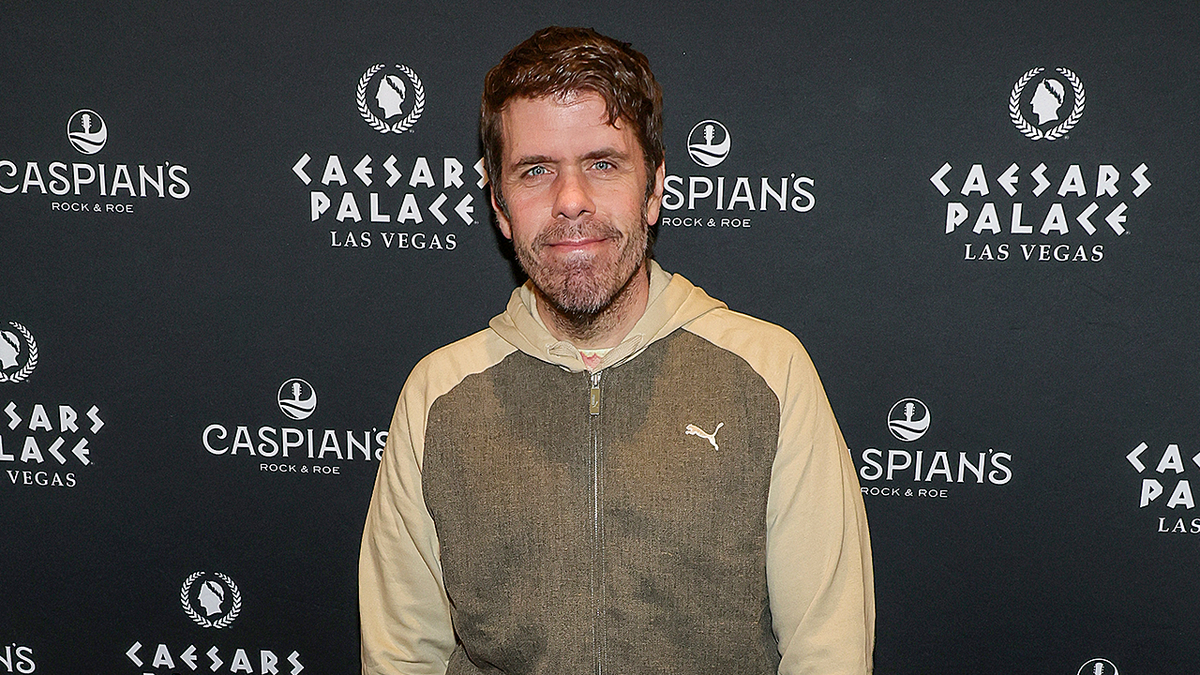 Perez Hilton standing on red carpet at Caspian's Cocktails & Caviar grand opening