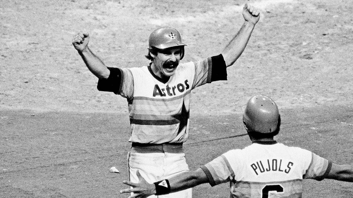 Houston Astros' Phil Garner scoring winning run greeted by Luis Pujols