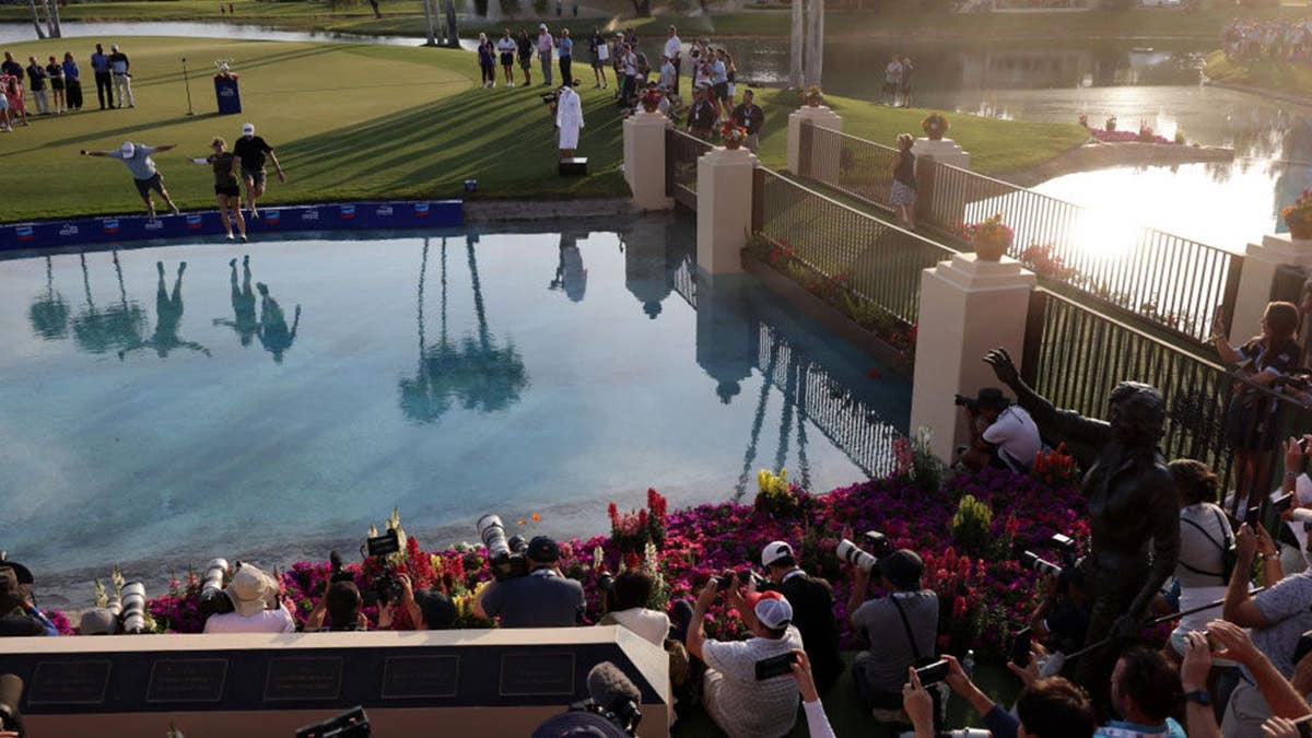 Jennifer Kupcho of the United States jumps into Poppie's Pond