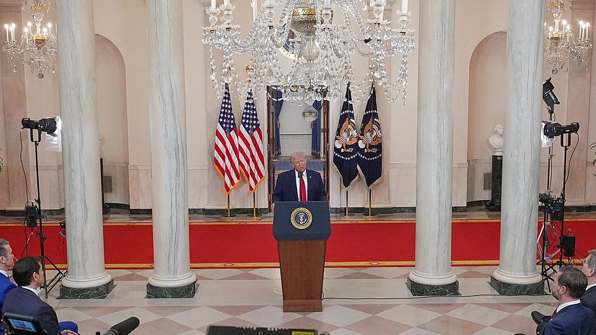 President Donald Trump speaking about the Iran war from the Cross Hall of the White House.