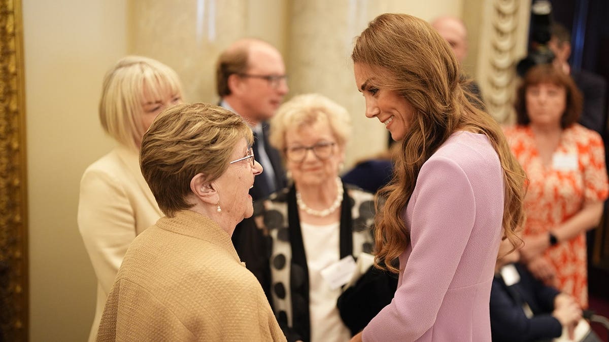 Catherine Princess of Wales speaking with 100 year-old Joan Illingworth at Buckingham Palace