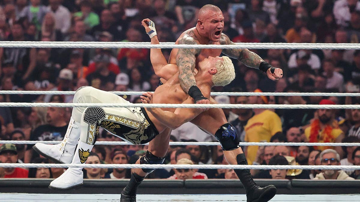 Randy Orton making contact with Cody Rhodes during a wrestling match at Allegiant Stadium