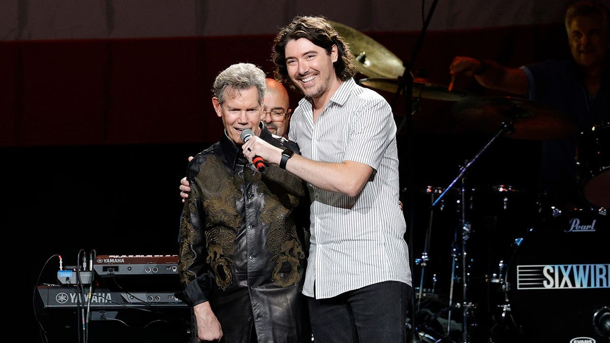 Randy Travis and James Dupre performing on stage at Bridgestone Arena in Nashville