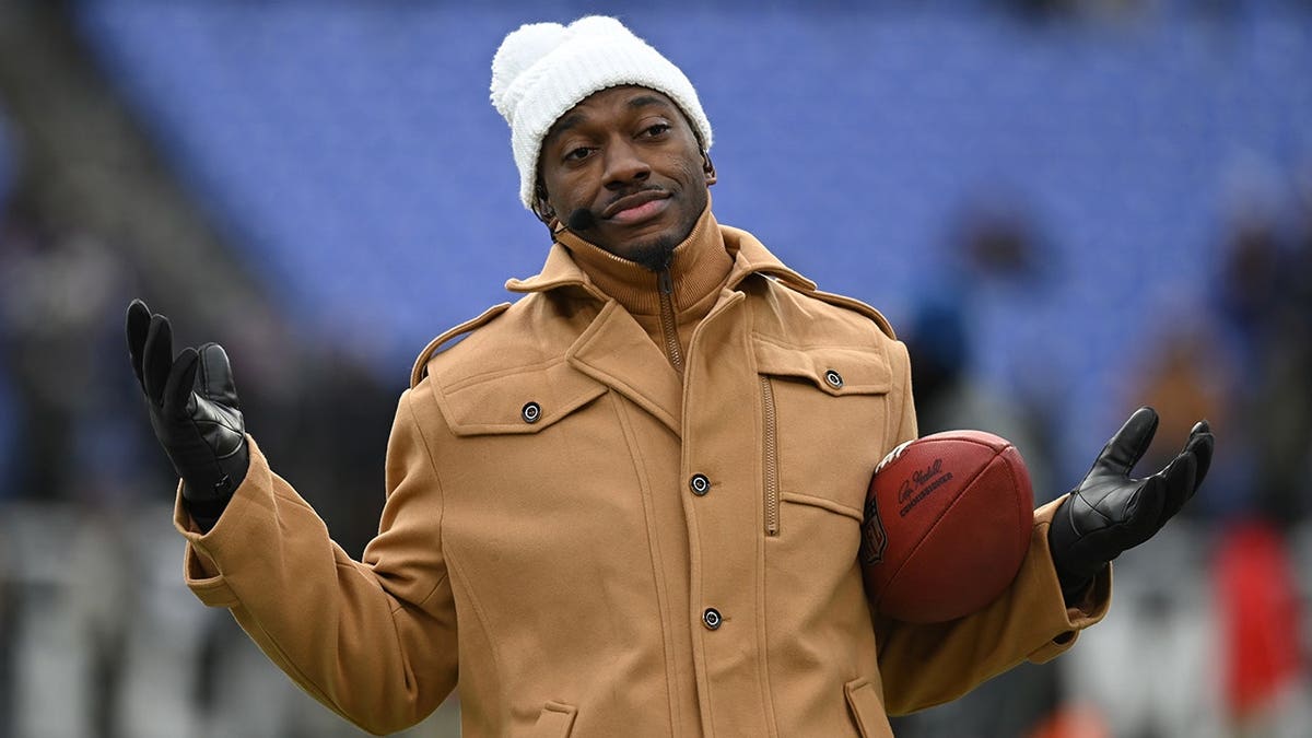 ESPN analyst Robert Griffin III reacting on sidelines at M&T Bank Stadium