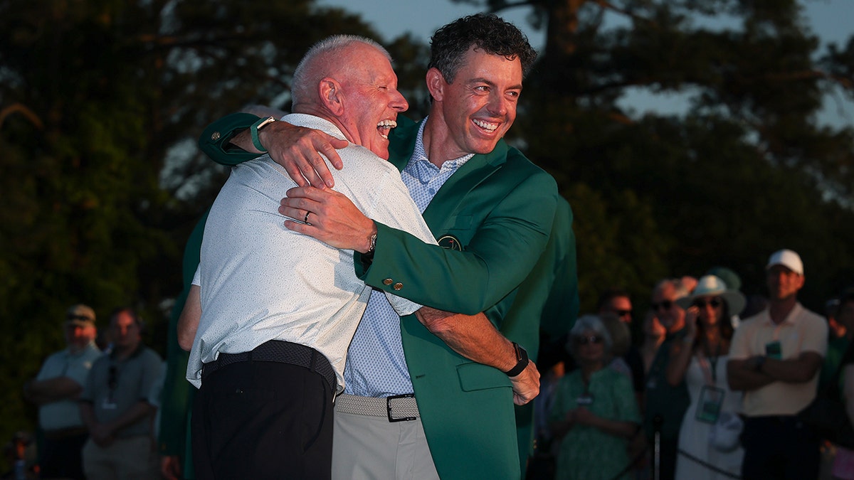 Rory McIlroy celebrates with his father at Augusta National Golf Club.