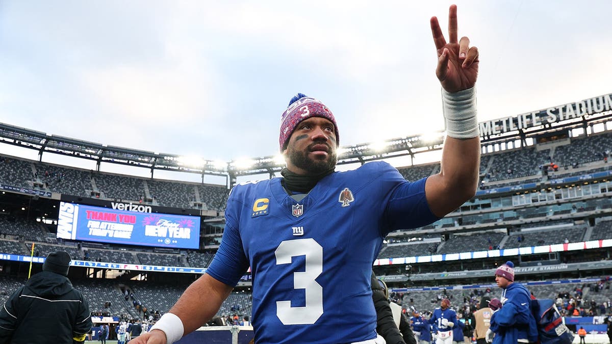New York Giants quarterback Russell Wilson waving to fans at MetLife Stadium
