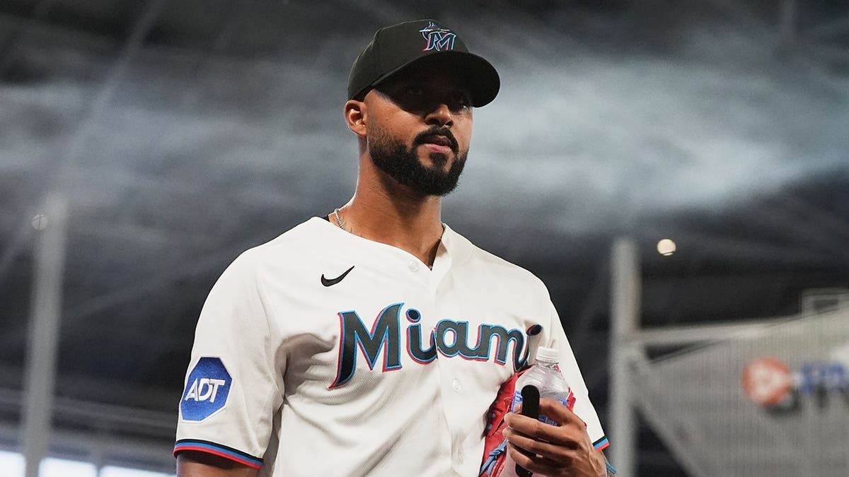 Miami Marlins starting pitcher Sandy Alcantara walking to the dugout before a baseball game
