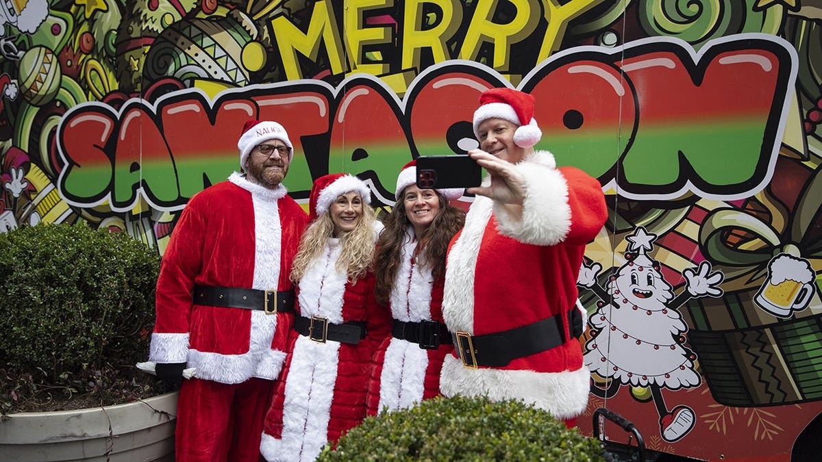 People dressed as Santa Claus walking in New York City during SantaCon celebration