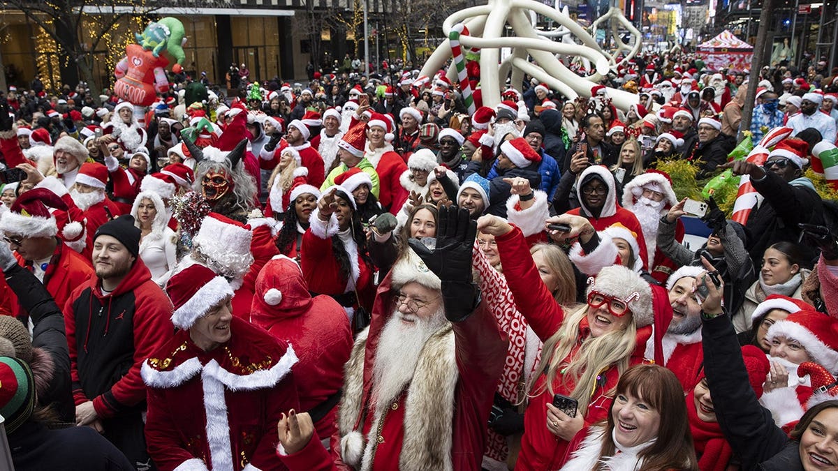 People dressed as Santa Claus walking in New York City during SantaCon celebration