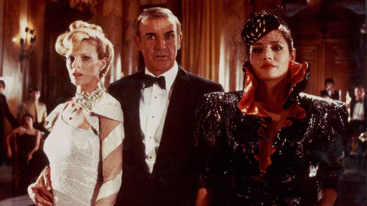 Actor Sean Connery as James Bond with Kim Basinger and Barbara Carrera in a film scene