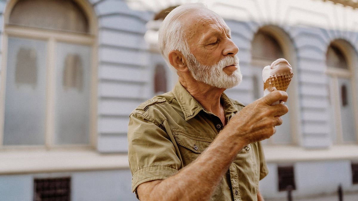 Senior man eating ice cream outdoors