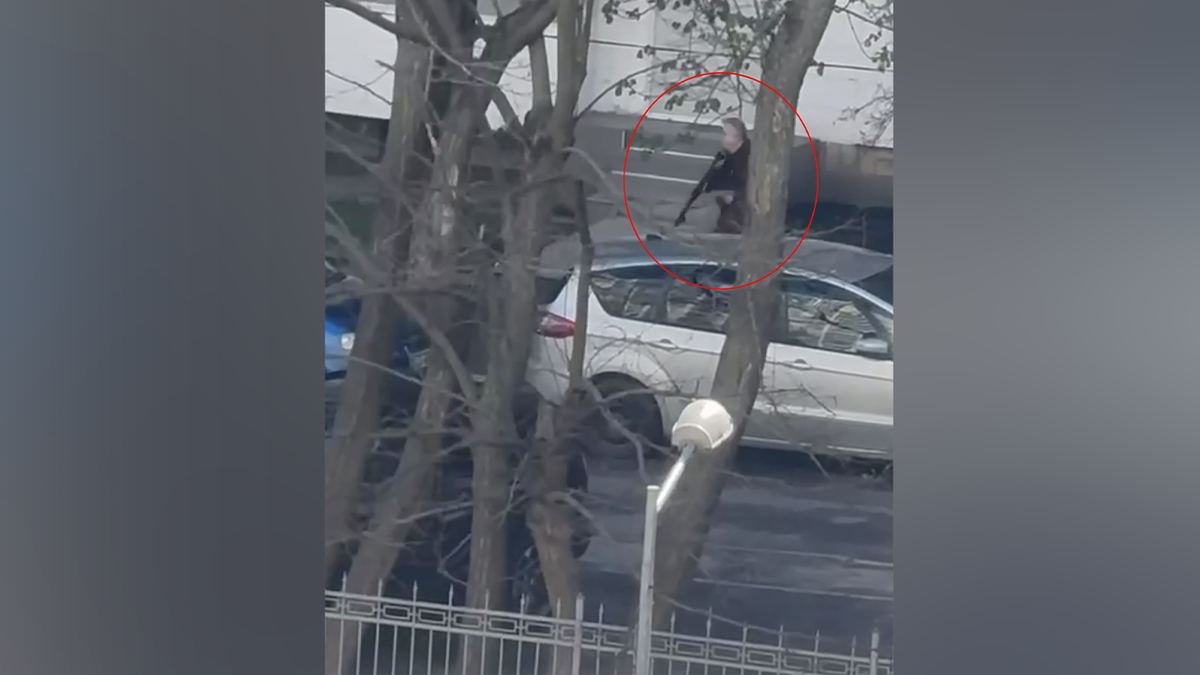 The gunman was seen walking with a weapon on the street.