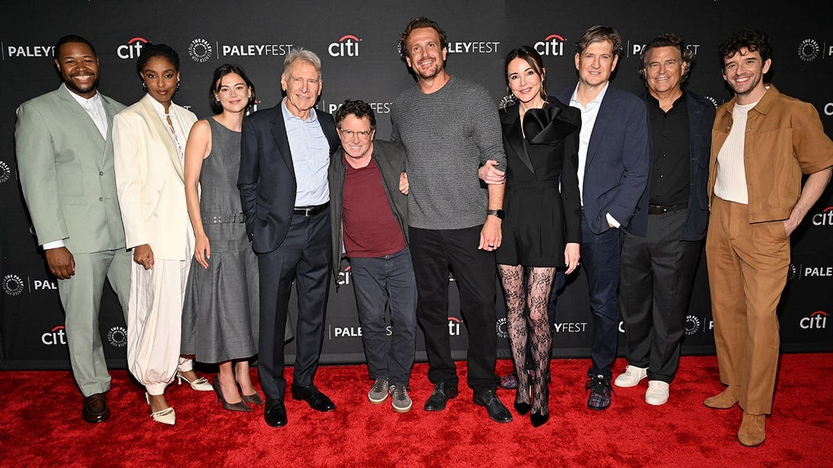 Luke Tennie, Jessica Williams, Lukita Maxwell, Harrison Ford, Michael J. Fox, Jason Segel, Christa Miller, Bill Lawrence, Ted McGinley, and Michael Urie standing at Dolby Theatre