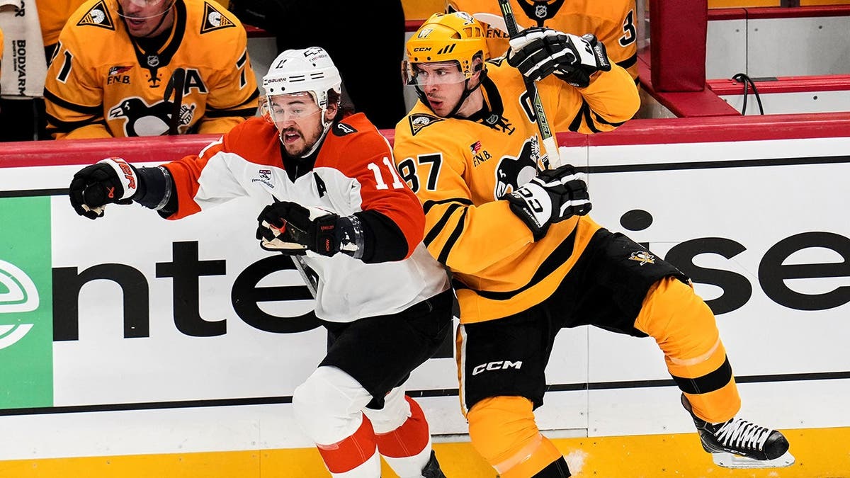 Sidney Crosby colliding with Travis Konecny on ice during NHL playoff game