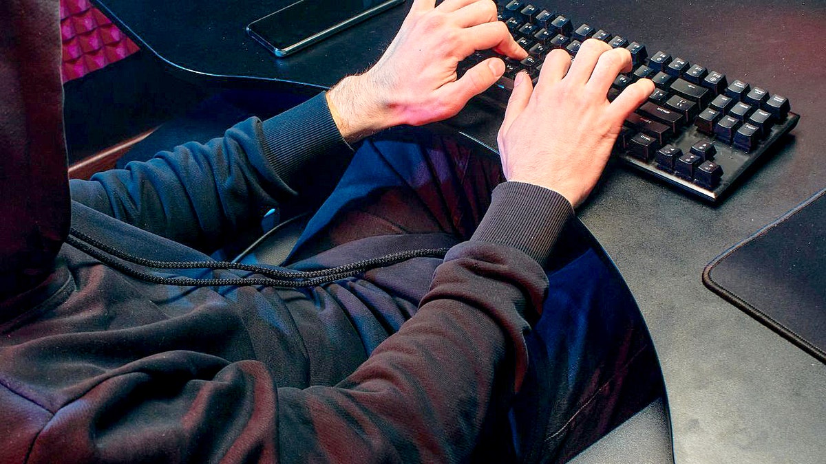 A hacker typing on a computer