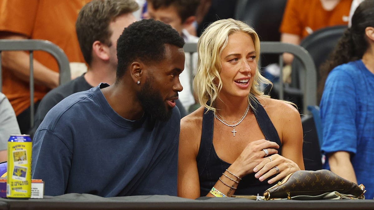 Sophie Cunningham sitting courtside during NCAA women's basketball semifinal game