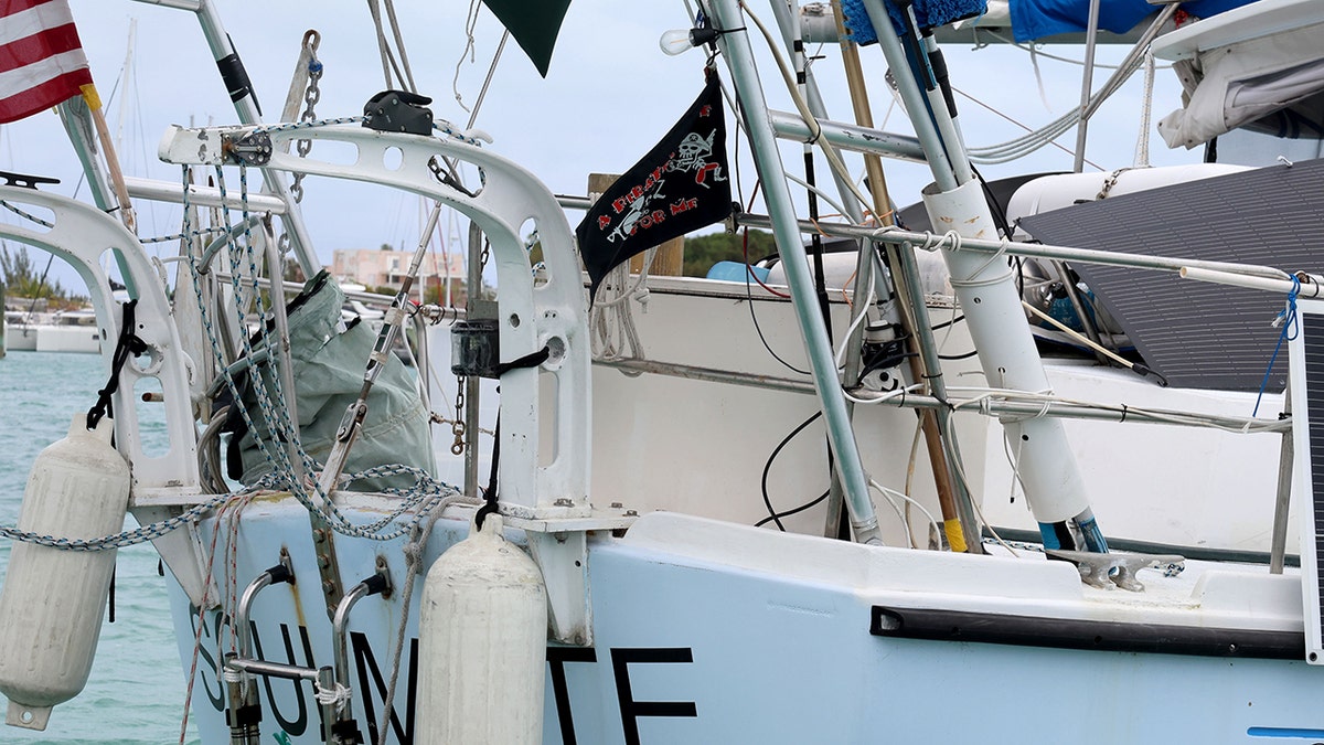 Soulmate boat anchored in calm turquoise water near a shoreline.