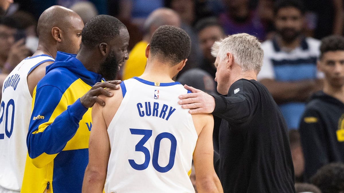 Draymond Green, Stephen Curry, and Steve Kerr together on basketball court during NBA play-in game