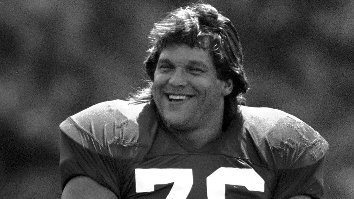 Steve McMichael smiling and looking on at Chicago Bears training camp