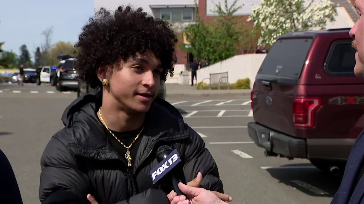 A high school student speaking to a reporter