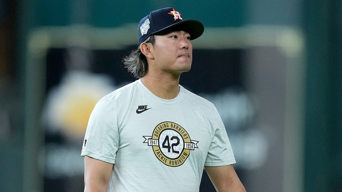 Houston Astros pitcher Tatsuya Imai warming up on the field