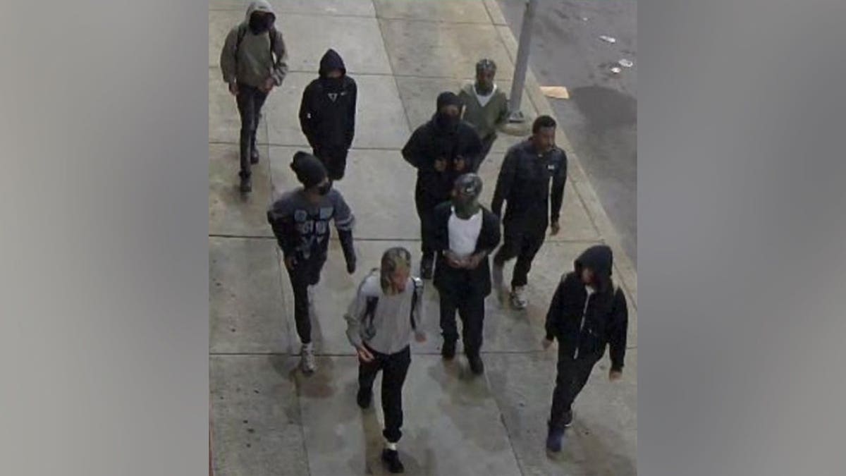 Authorities are searching for a group of nine suspects accused of chasing a Temple University student into an on-campus residential hall lobby and attacking them