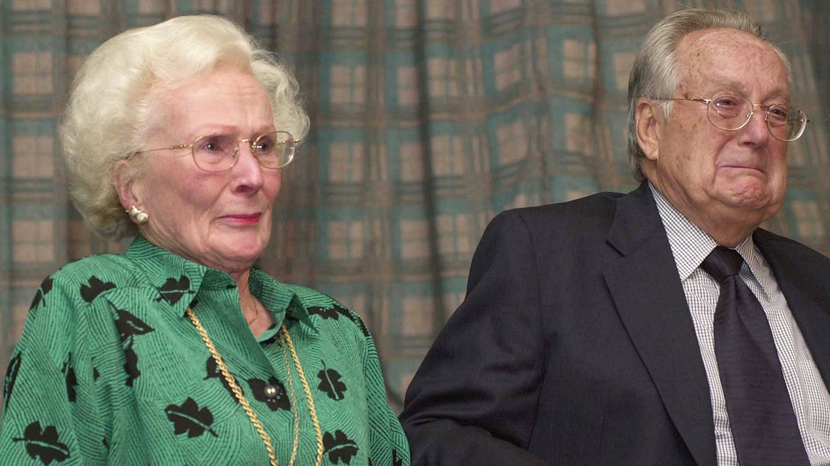 Barbara and Harry Cresman standing at a press conference in London.