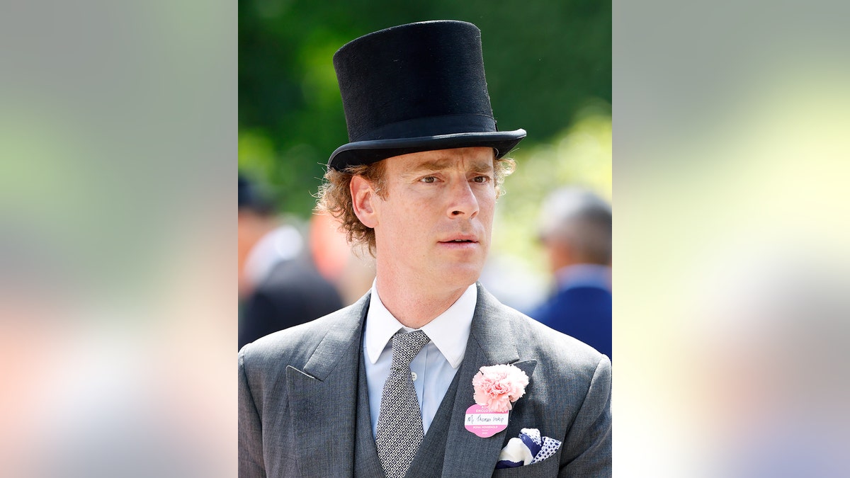 Tom Inskip wearing a grey suit and a black top hat at Royal Ascot.