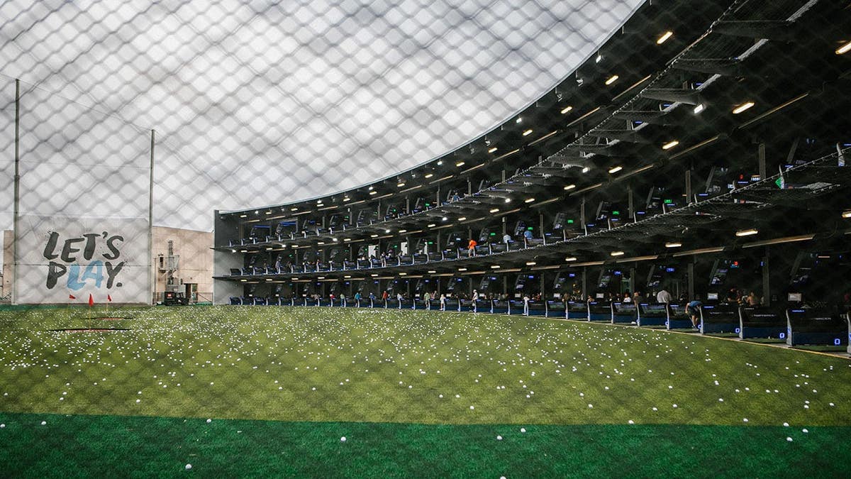 A sea of golf balls covering the range at Topgolf in El Segundo, California