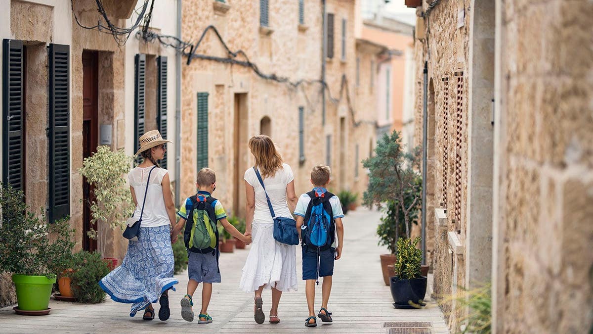 Majorca, Menorca and Ibiza want to cap visitor numbers as overtourism surges 3 Mother holding hands with three children