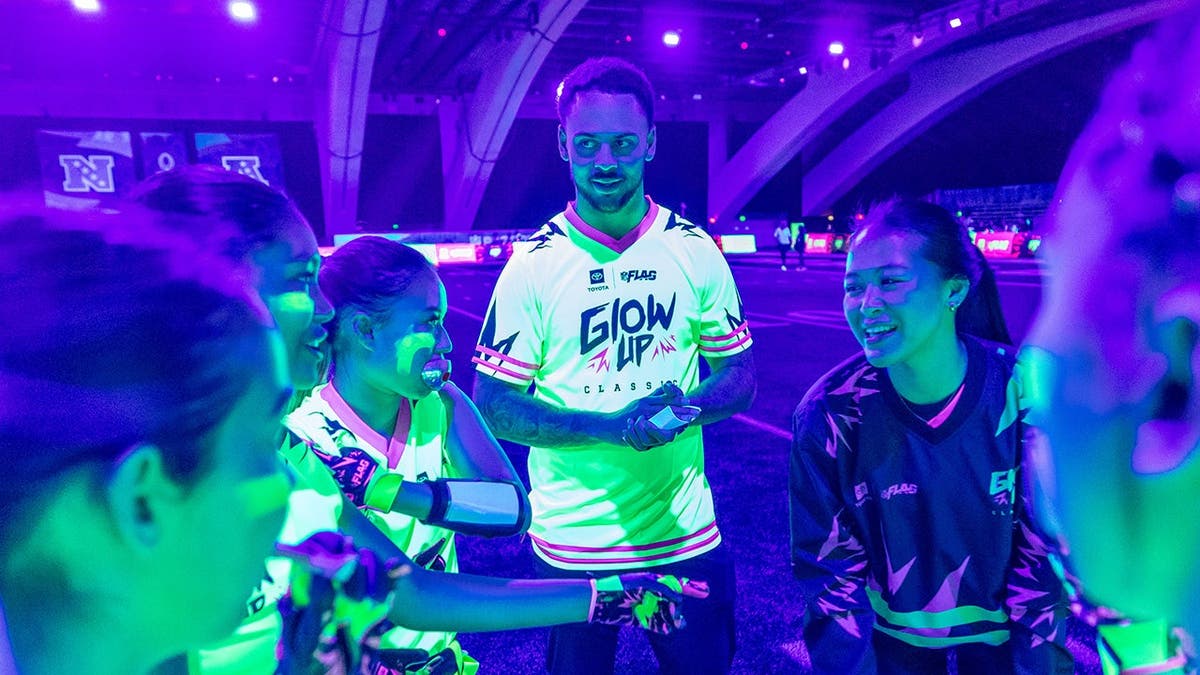 Young players participate in glow-in-the-dark flag football at the Super Bowl Experience in San Francisco