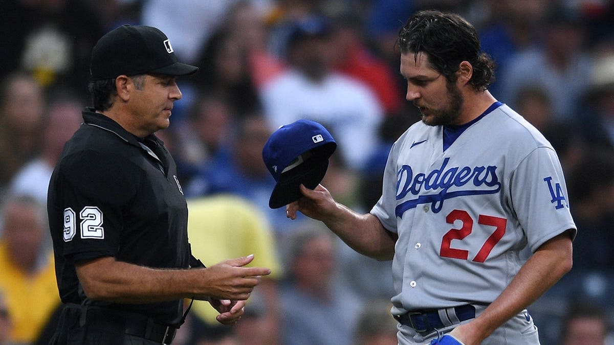 Los Angeles Dodgers pitcher Trevor Bauer being checked by umpire James Hoye at Petco Park