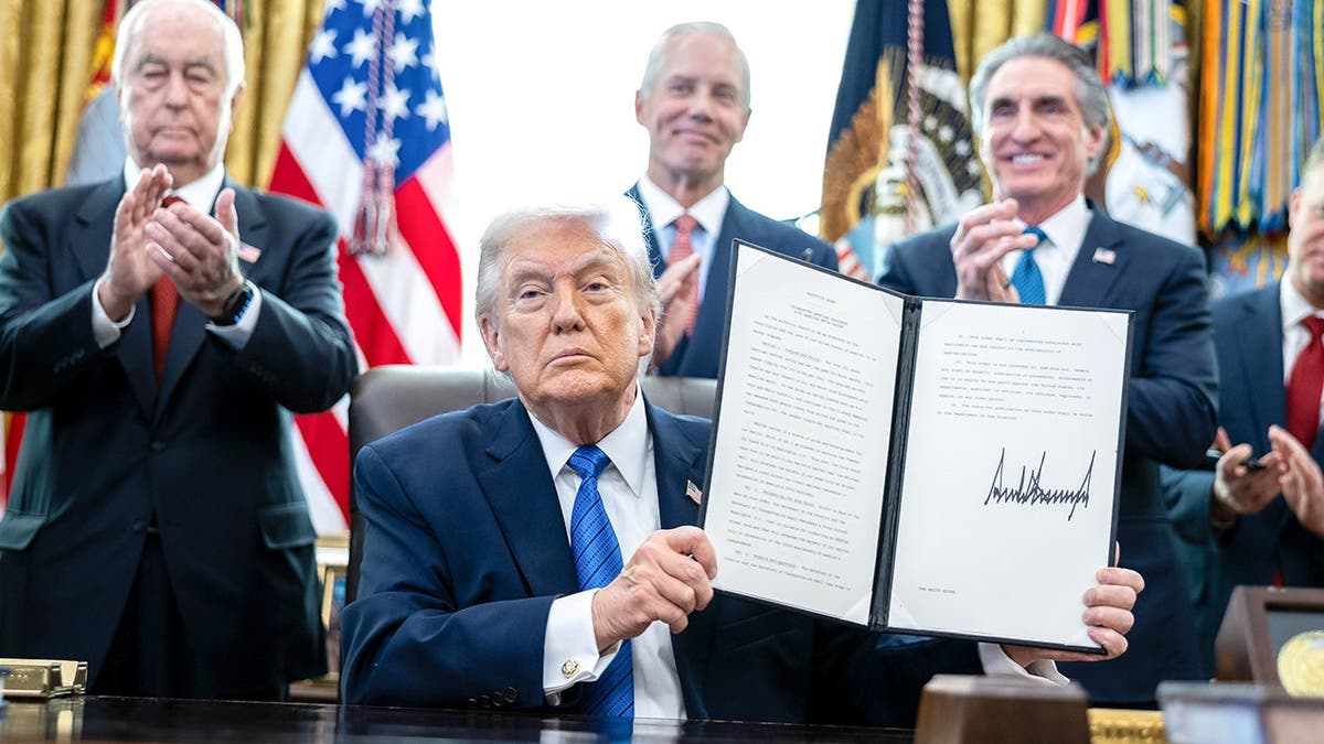 Trump holds signed executive order in Oval Office announcing IndyCar race plan.
