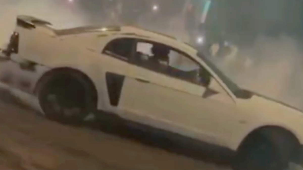 White sports car drifting during illegal street racing takeover in Tucson before police crackdown