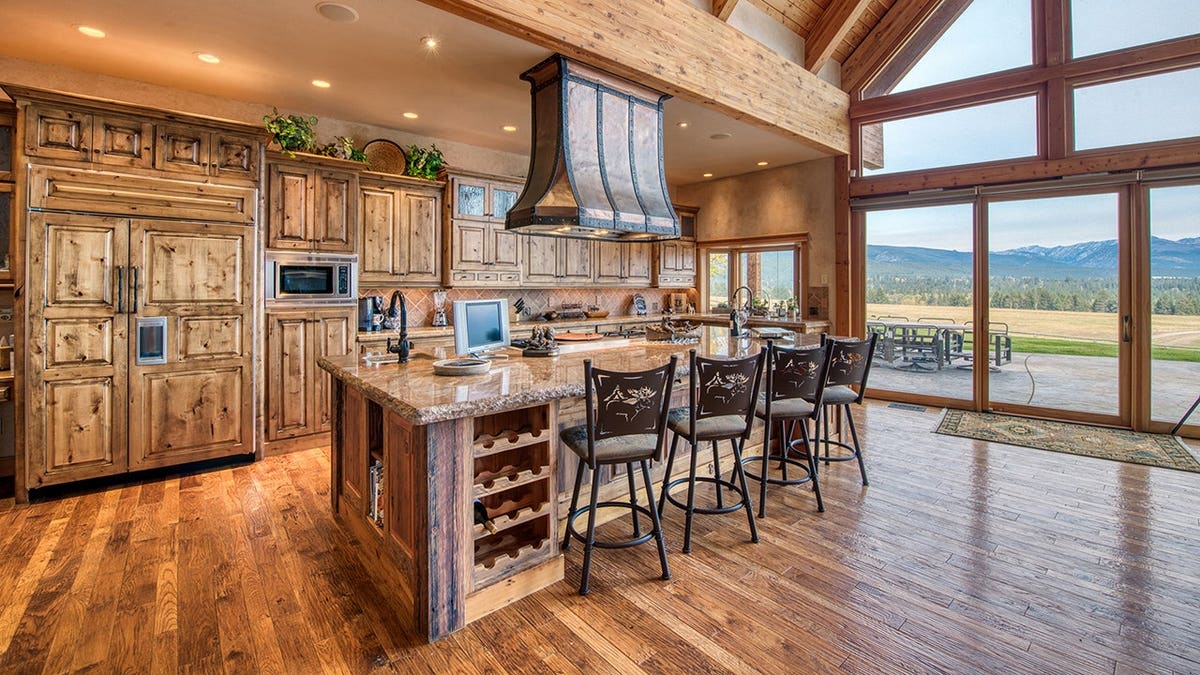 Rustic kitchen with wood cabinets, large island and mountain views