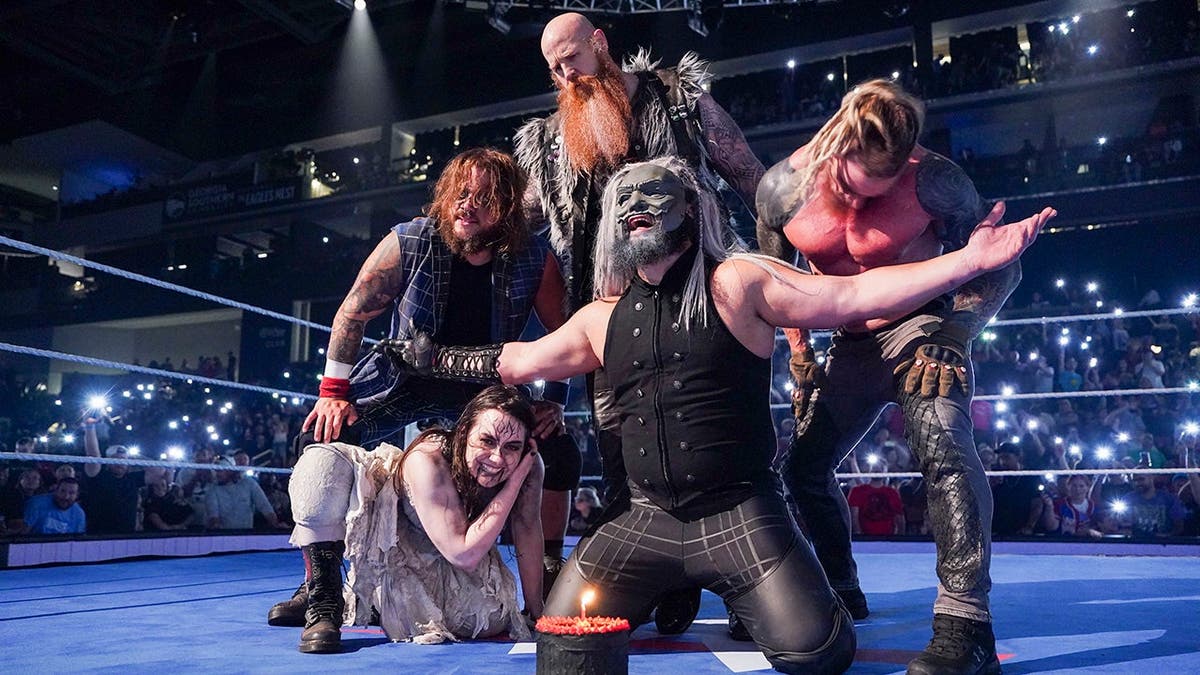 Uncle Howdy, Erick Rowan, Dexter Lumis, Joe Gacy, and Nikki Cross standing together during SmackDown event.