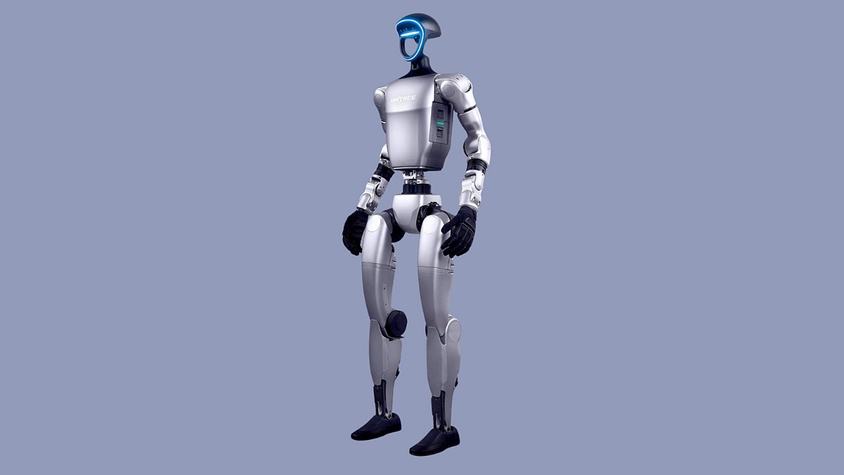A robot standing against a grey background