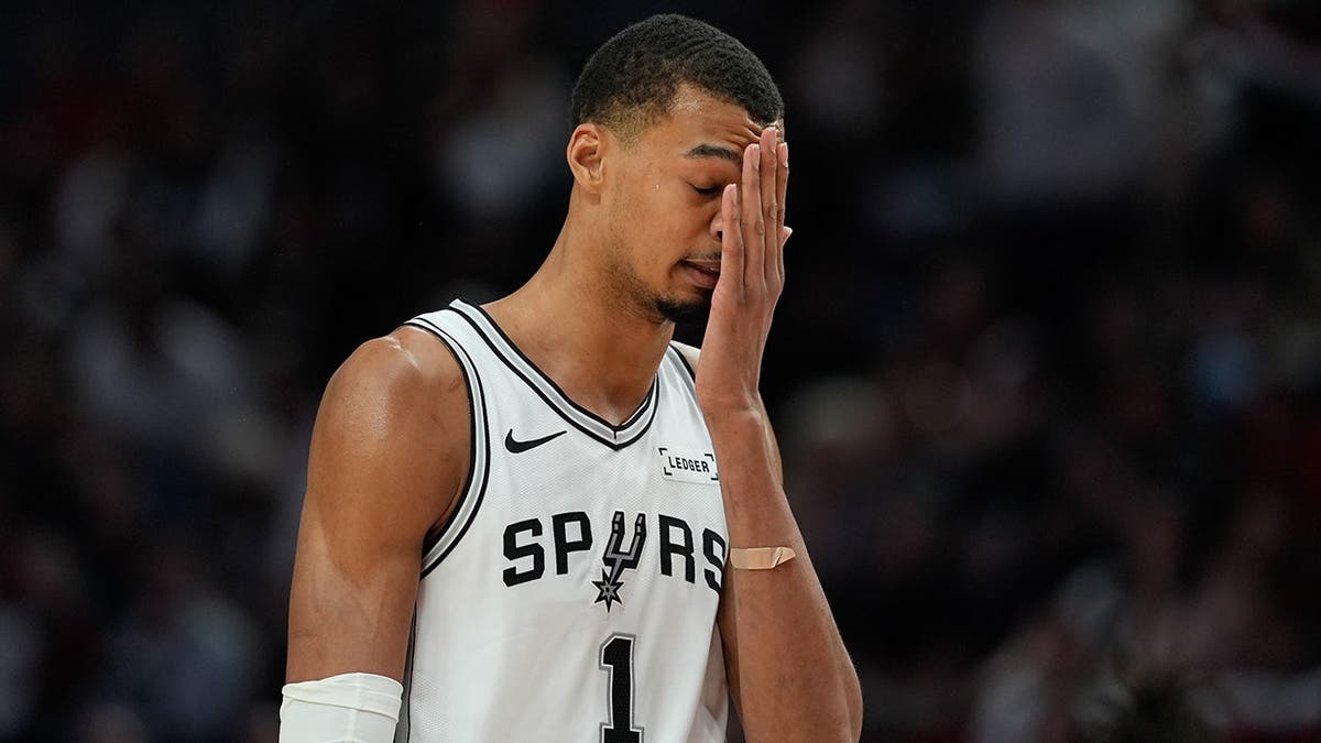 San Antonio Spurs forward Victor Wembanyama reacting during a basketball game.