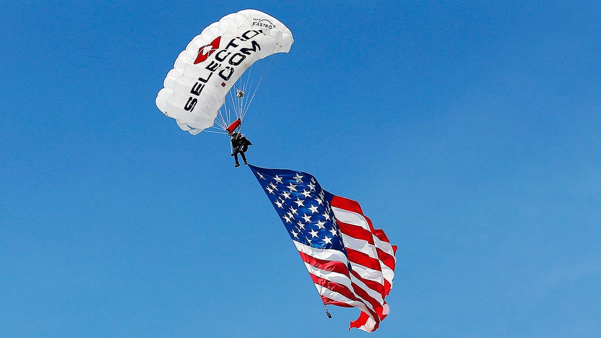 A skydiver attempting to land during strong winds at Lane Stadium in Blacksburg, Va.